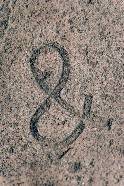 Ampersand sign carved on the stone. Symbol on granite. Stone engraving