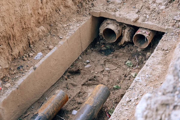 Pipeline repair in Kazakhstan. Replacing old pipes in shymkent. Dismantling of iron pipes on the street. — Stock Image Pipeline Repair Kazakhstan Replacing Old Pipes Shymkent Dismantling Iron Pipes Stock Photo