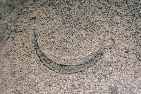 A crescent sign carved on a stone. Heavenly sign on granite. Stone engraving