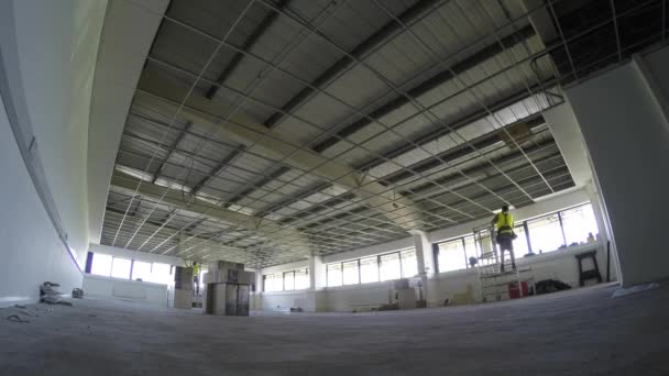 Construction Installing Ceiling Tiles To The Grid In Large Area