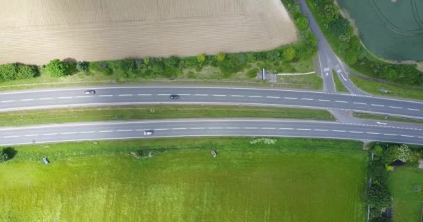 Aerial view of sittingbourne road or dual carriageway with green fields in the background and fast moving traffic, Kent, England, UK — Stock Video