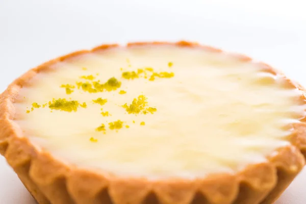 One single lemon tart, isolated on white.