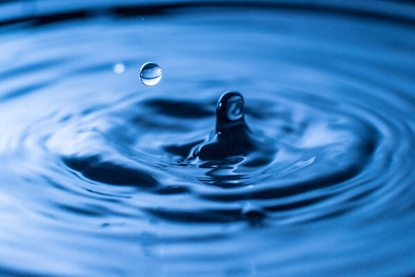 water drop splash in a glass blue colored