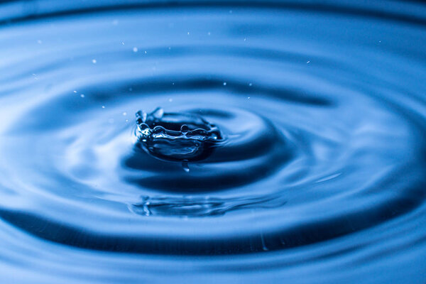 water drop splash in a glass blue colored