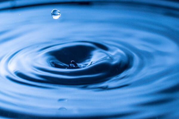water drop splash in a glass blue colored