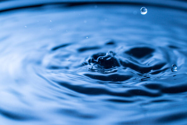 water drop splash in a glass blue colored