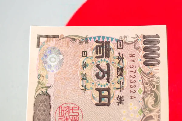 Japanese currency notes , Japanese Yen on japanese flag.