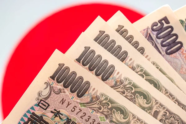Japanese currency notes , Japanese Yen on japanese flag.