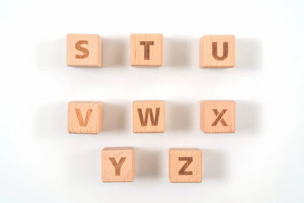 Alfabeto sobre madera, fondo blanco — Foto de Stock