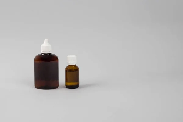 gri arka plan üzerinde iki kahverengi cam şişe