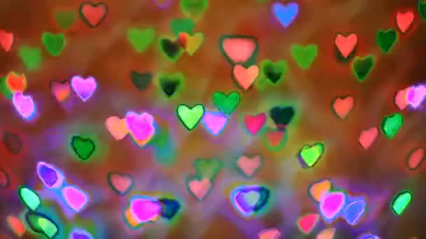 ネオン効果の背景として使用される心臓の形をしたカラフルな花輪ボケを点滅 — ストック動画