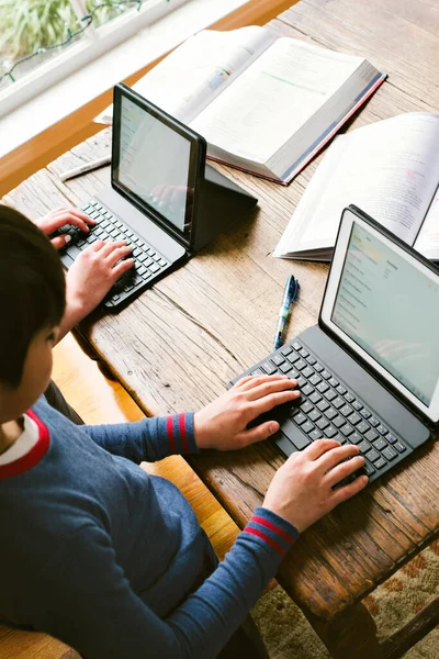 View of hands of students on laptops learning remotely - Covid 19 - Corona Virus - Remote Schooling