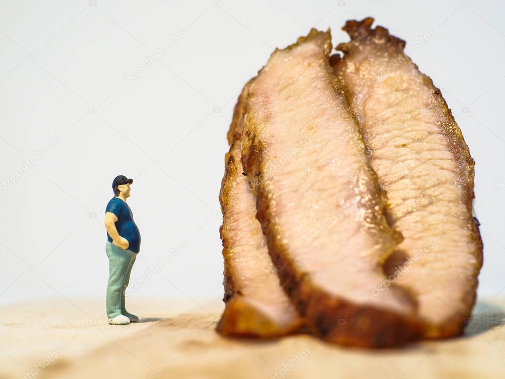 Miniature people, Close up fat man with grilled pork neck on white background with copy space