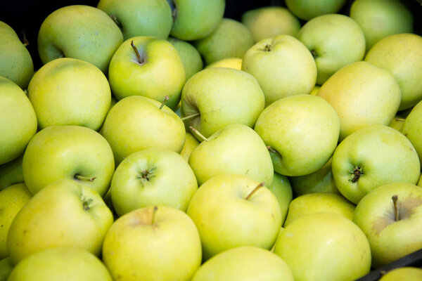 fresh fruit, ripe apples on the counter in the supermarket