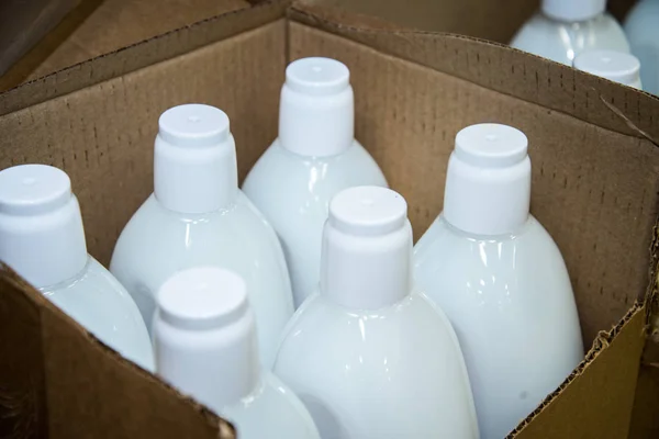 Packaging of cosmetic spray made from aluminum and plastic bottle caps on top view, many shampoo bottles in carton