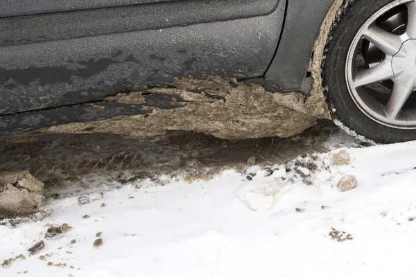 Dirty car tire with snow. Chemical reagents