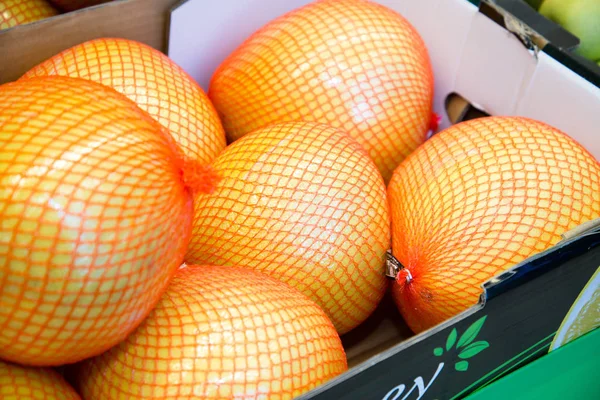 fresh citrus fruits are on the counter in the store.