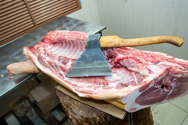 Large ax for chopping meat, meat carcass. Close up. Large piece of meat. Butcher profession — Stock Photo, Image