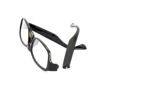 Broken eye glasses, isolated on white background. Black celluloid frame. — Stock Photo, Image