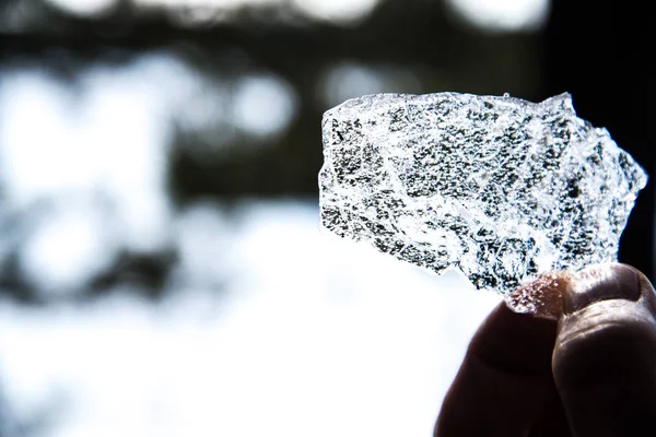 Big piece of shiny ice in hand, the ice is melting in the hand. — Stock Photo, Image