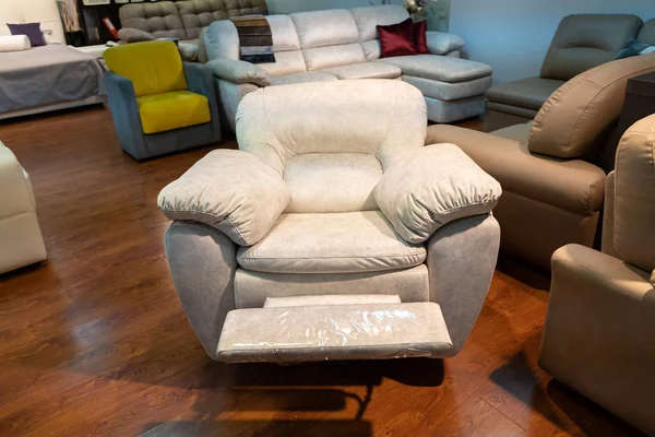 New leather chair in the store. Sofas and chairs are exhibited in the furniture store. Sale.