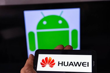 Magdeburg Almanya - Haziran 2019: Android akıllı telefon Honor tutan bir adam. Ekranda, Android logosu önünde huawei logosu. Google, Huawei'nin Android sistemine erişimini kısıtlar.