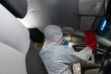 Kuru Temizleme salonu araçları. İşçi arabada yıkama Vakum kullanır.