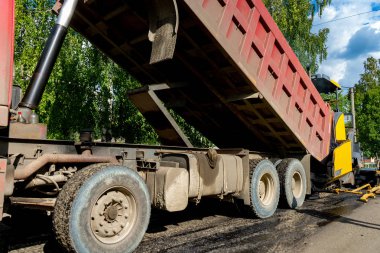  Sıcak asfalt yüklüyor. Yol tamiri. Asfalt döşeme. Yeni bir asfalt tabakası döşeme.