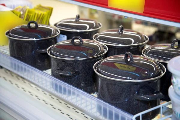 Casseroles émaillées noires avec couvercle dans le magasin — Photo