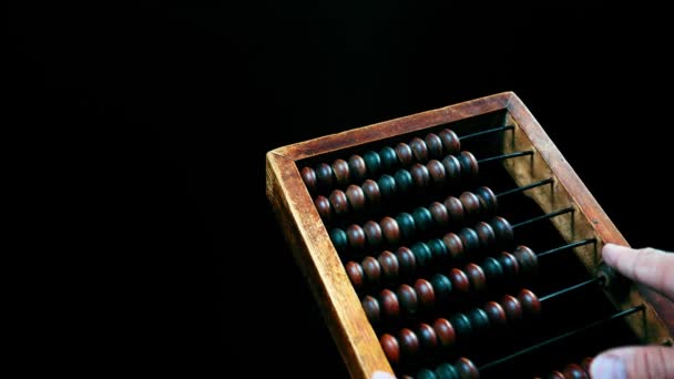 Vintage wooden abacus. Part of the old end of the abacus on a dark background. — Stock Video