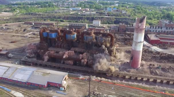 The collapse of an obsolete industrial chimney with an explosion. Disposal of an obsolete metallurgical plant. Aerial video filming from a drone — Stock Video