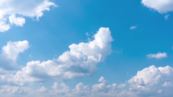 Nuvens brancas de cúmulo giram contra o céu azul. — Vídeo de Stock