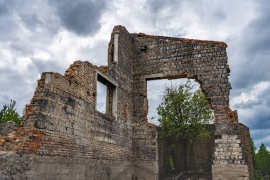 Yıkılmış duvar. Duvarın parçaları gökyüzüne karşı. Harabeler. Yaz günü