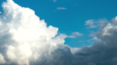 Hava değişikliği. Parlak güneşli bir günde, beyaz bulutlar hızlı hareket eder ve kara bulutlar tarafından gizlenir.