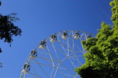 Dönme dolap mavi gökyüzü arka plan üzerinde beyaz kabin