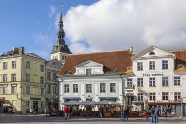 Town Hall Square (Raekoja plats) in the city of Tallinn in Estonia. The steeple is St. Nicholas Church (Niguliste Kirik).  clipart