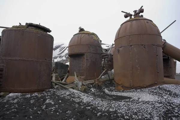 Rusting remains of the boilers of an old abandoned whaling station on Deception Island in Antarctica.