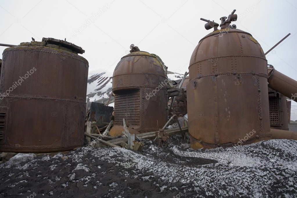 Rusting remains of the boilers of an old abandoned whaling station on Deception Island in Antarctica.