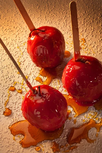 Toffee Apples or Candy Apples - whole apples covered in a hard sugar candy coating. While the topping varies from place to place, they are almost always served with a stick of sorts in the middle making them easier to eat.