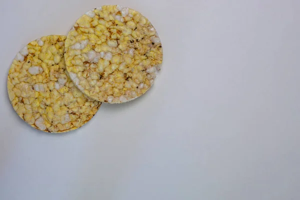 corn and rice cakes fitness food on white background copy space close-up