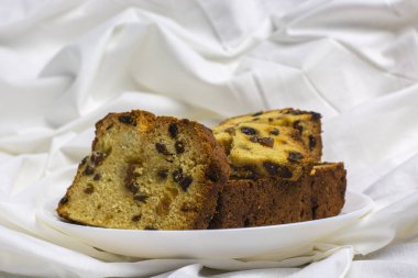 Kuru üzümlü kek ve beyaz tabakta sabah kahvaltısı yakın.