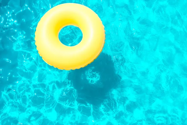 阳光明媚的日子里 充气戒指在游泳池里游泳 漂浮在蓝色水面上的空橡胶圈 — 图库照片