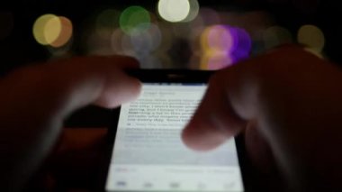 Akıllı telefon bağımlılığı kavramı-Hands tutarak akıllı telefon ve kaydırma Facebook App sonsuz-sosyal ağ
