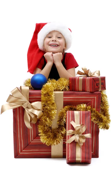 Noel Baba şapkası ile izole beyaz bir arka plan üzerinde Noel hediyeleri, sevimli küçük kız
