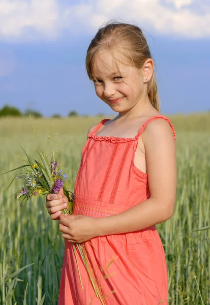 Menina Bonito Vestido Vermelho Campo Verde Com Buquê Flores Céu — Fotografia de Stock