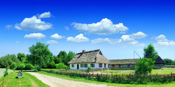 Panoramic landscape, view of an old abandoned village, in the background blue sky and white clouds