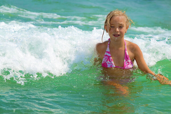 Cute girl playing in the sea