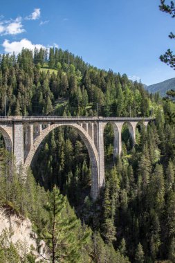 View from the historic Wiesen Viaduct of the Rhaetian Railway near the village Davos Wiesen, Swiss Alps clipart
