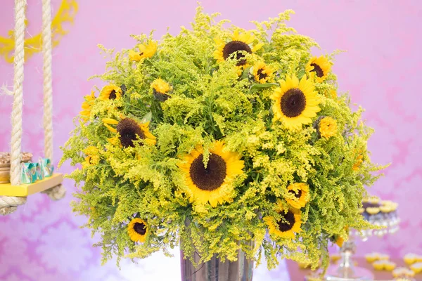 Sunflowers in the vase on the table
