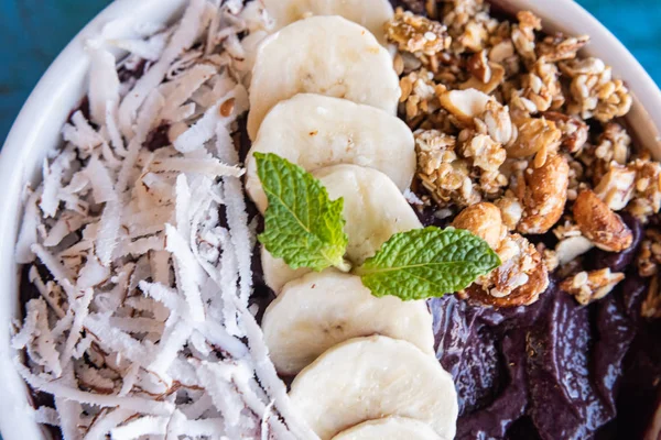 Acai in the bowl with coconut banana mint and other ingredient — Stock Photo, Image